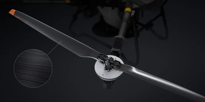 A carbon fibre composite propeller mounted on a DJI Agras arm