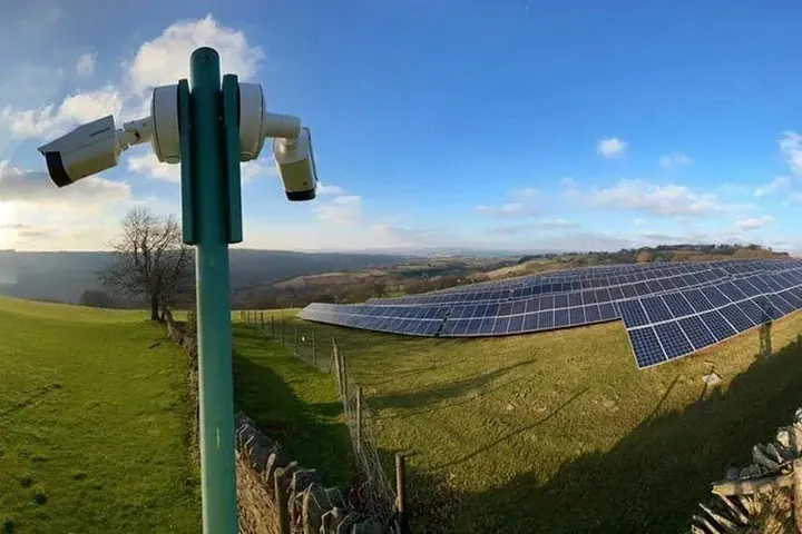 Security camera pole overlooking a farm installation
