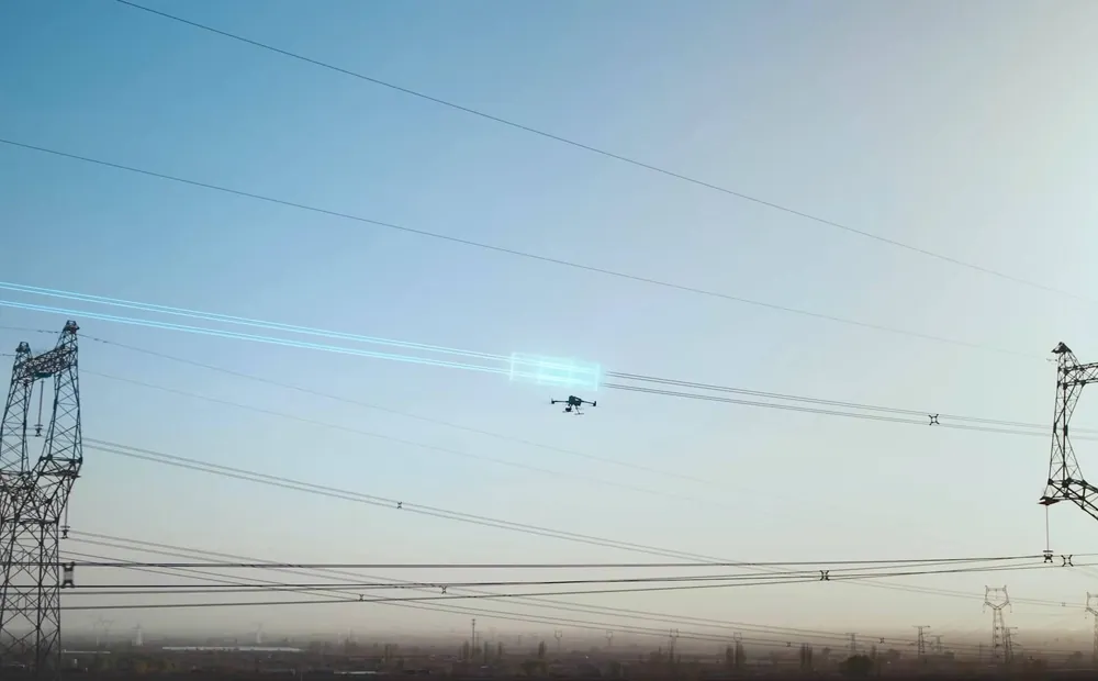 DJI Matrice 400 laser scanning a power line between two pylons