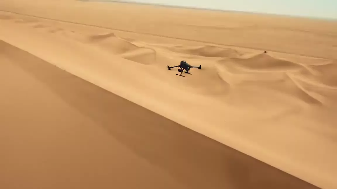 DJI Matrice 400 flying low over dune terrain