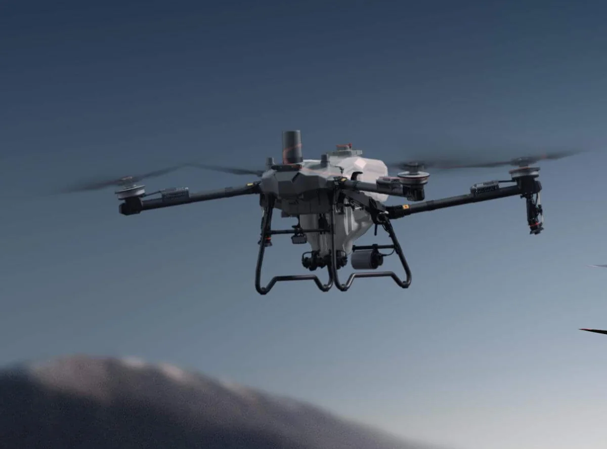 DJI Agras T70P in flight at dusk
